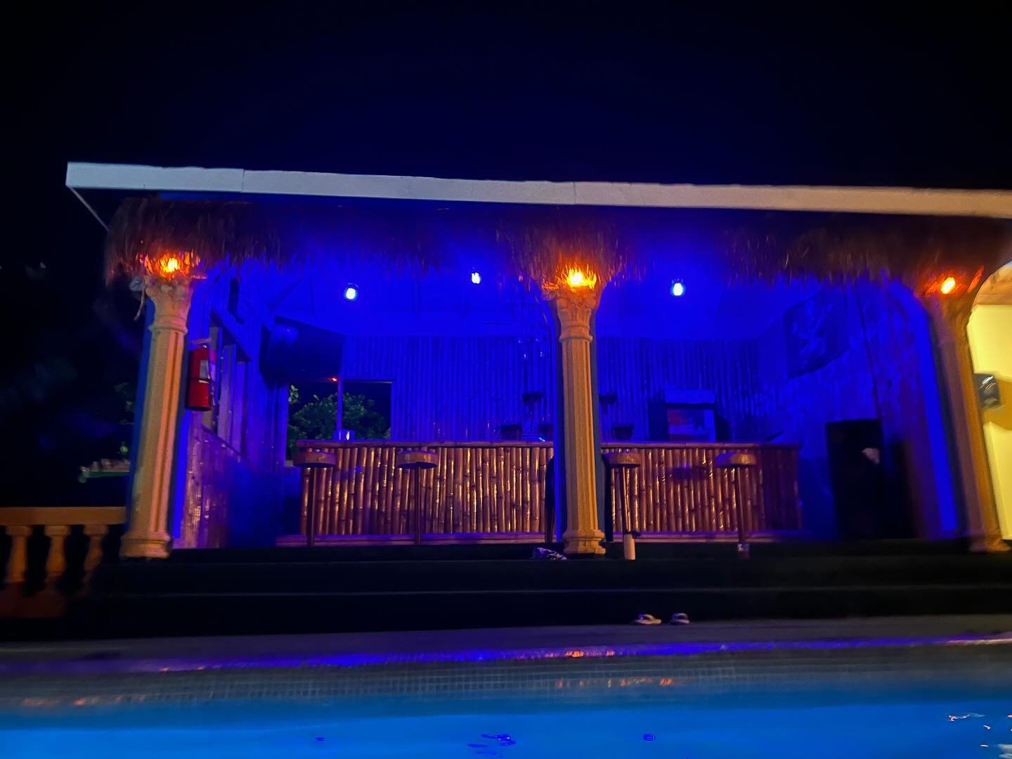 Pool bar lit up at night at Rum Runners Resort