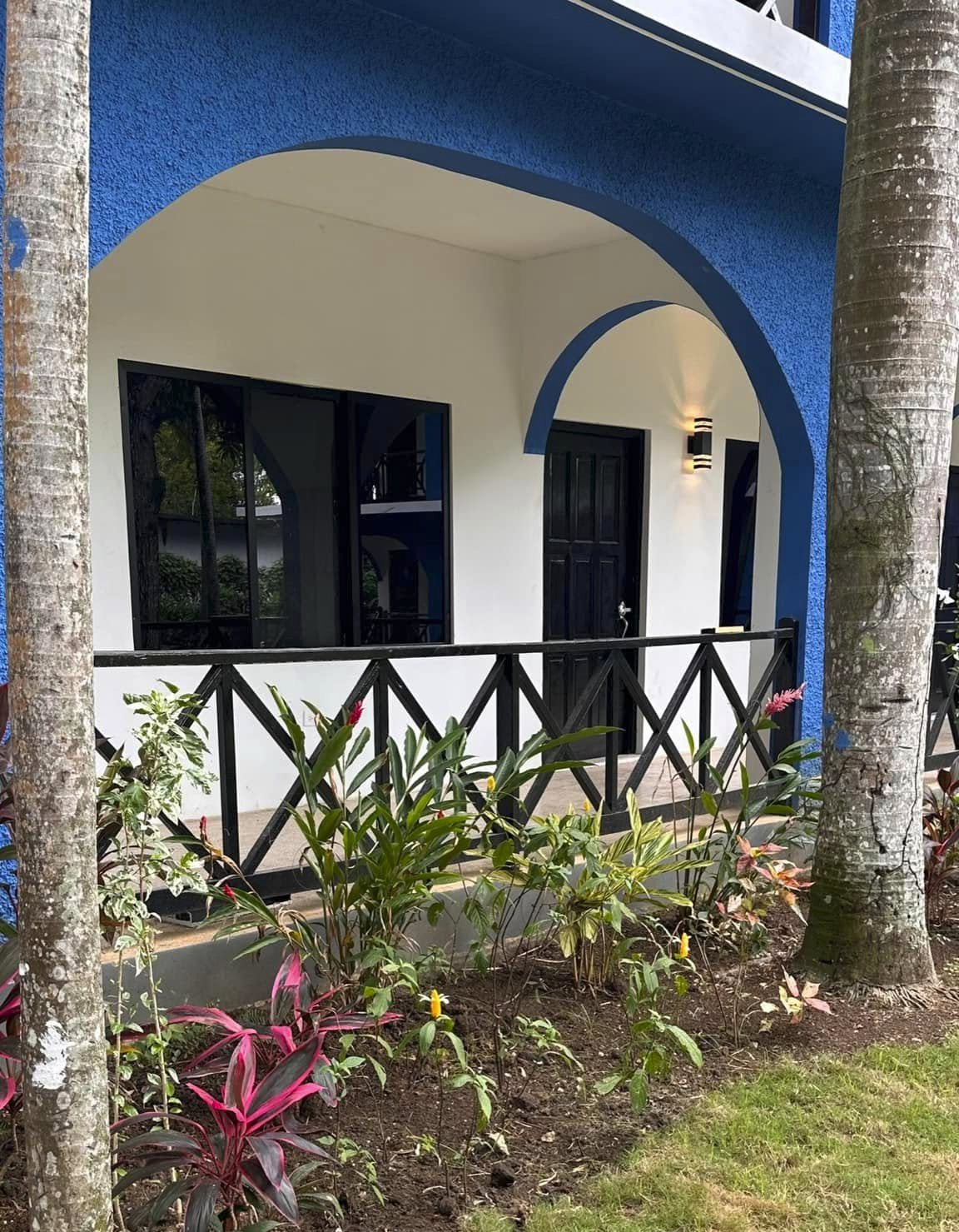 Blue and white guest room entrance at Rum Runners Resort