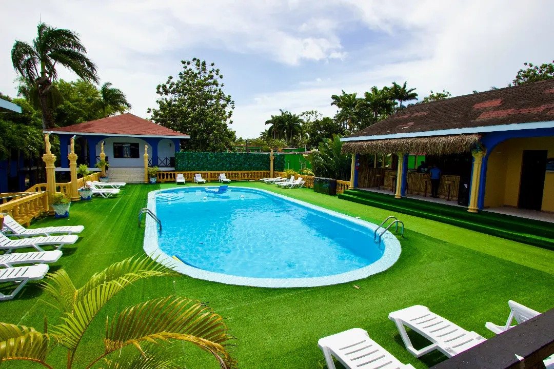 Pool, sun loungers and bar at Rum Runners Resort